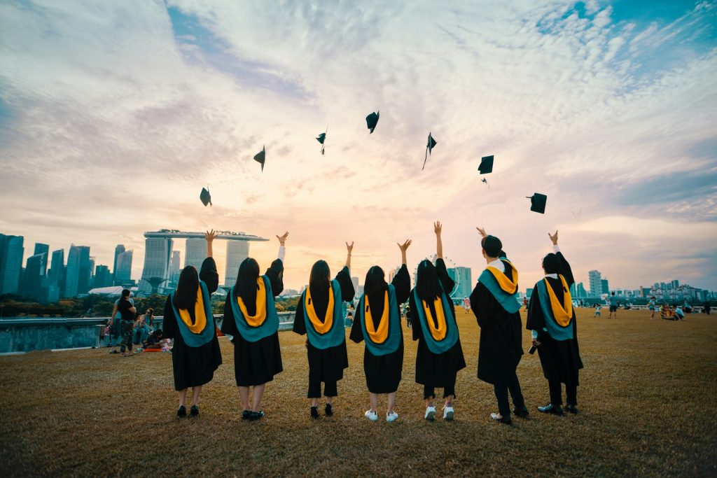 Graduates tossing caps in the air at commencement